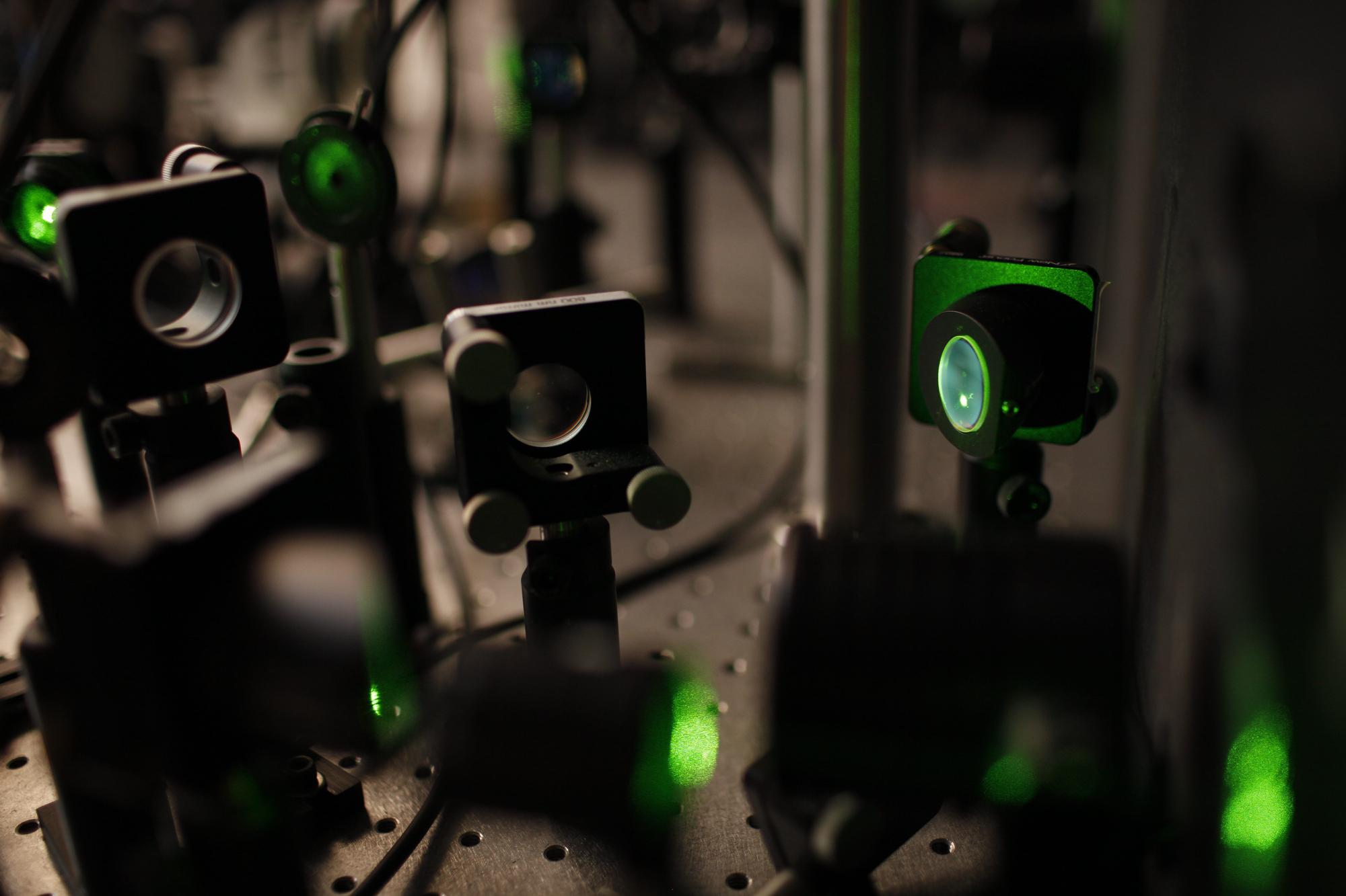 A closeup of laser table covered in beam-steering implements